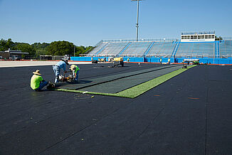 A thorough look into the installation process of synethetic turf at Spring Grove Area High Schoolon REGUPOL abzorb synthetic turf shock pad. The installation process ensures a high-quality surface for athletes.