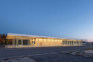 View of the Neil Campbell Rowing Centre facility, features full glass walls, demonstrating the innovative design of the facility. 