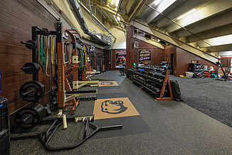 Initial view when entering the Hershey Bear's weight room in the GIANT Center. The various equipment and turf provide a comprehensive space for the athletes to train.