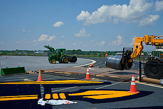 View of the construction and installation taking place of REGUPOL abzorb to the ELCO High School field. The REGUPOL abzorb material is being transported onto the field. 