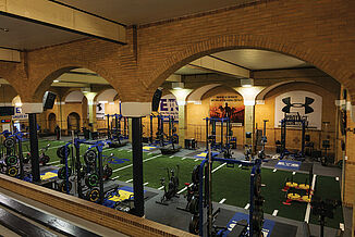 Expansive view of the Elite Training Systems facility in the Honorable W.C. Kennedy Collegiate. The facility provides a variety of athletes to perform workouts and exercises, all while on REGUPOL aktivpro roll flooring. 