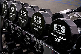 Close view of the dumbbells at the Elite Training Systems located at the Iroquois Park Sports Centre. The dumbbells allow athletes to train atop REGUPOL flooring.