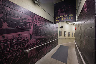 View of the GIANT Center hallway that leads to the Hershey Bears weight room. The hallway walls show past achievements of the AHL team.