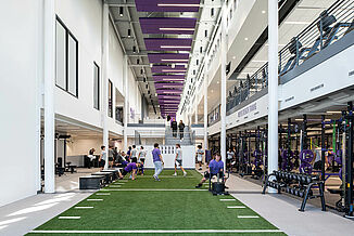 Long view of the turf area leading to the steps of the Cornell College Richard and Norma Small Athletic and Wellness Center.