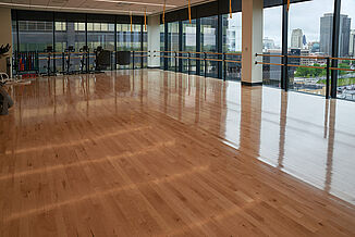 A section of the fitness center featuring hardwood flooring, providing a warm and inviting ambiance.