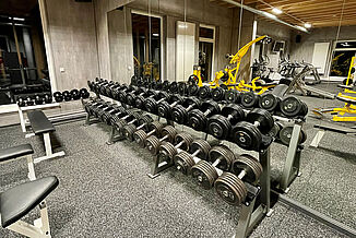 Training room with weight benches on REGUPOL gym flooring in the RhönFit therapy centre in Dermbach.