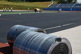 Rolls of REGUPOL abzorb as they are being installed on the Spring Grove Area High School field.