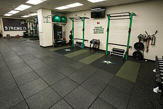 Squat racks in the Dallas Stars weight training facility, featuring REGUPOL aktivpro tiles throughout the facility.