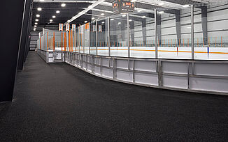 View of the ice rink at Thayer Sports Center. The walkway surrounding the rink is installed with REGUPOl aktiv rolled rubber flooring.