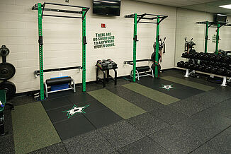 The Dallas Stars weight training facility offers a variety of equipment for athletic training purposes for athletes, such as weight racks and free weights. REGUPOL aktivpro tiles are used throughout the facility, with inlaid customized tiles to contain the team logo.