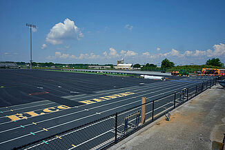 View of the ELCO High School track and turf field under renovation. REGUPOL abzorb is being installed at an underlayment before the synthetic turf is installed on the field.