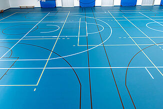 Sports hall with blue REGUPOL dynamic classic sports hall flooring and line markings