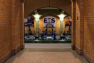 Hallway leading into the Elite Training Systems facility in the Honorable W.C. Kennedy Collegiate facility. The previous swimming pool area was renovated into a premium training facility, featuring REGUPOL flooring.