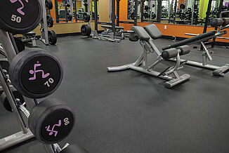 Anytime Fitness facility featuring REGUPOL sonusfit m520 flooring, as well as a variety of weight training equipment throughout the space.  