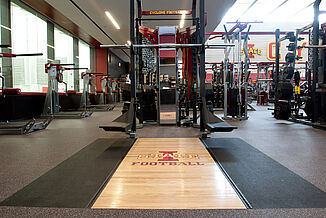 Iowa State University inlaid platform with REGUPOL aktivpro roll flooring and REGUPOL crash. 