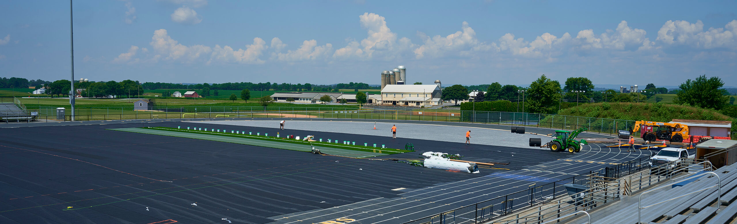 View of the ELCO High School track and turf field under renovation. REGUPOL abzorb is being installed at an underlayment before the synthetic turf is installed on the field.